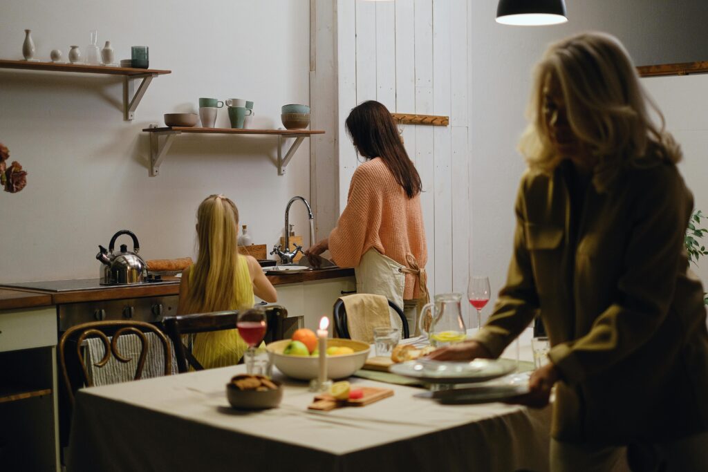 A family preparing meals in a cozy kitchen setting, emphasizing bonding and domestic life.