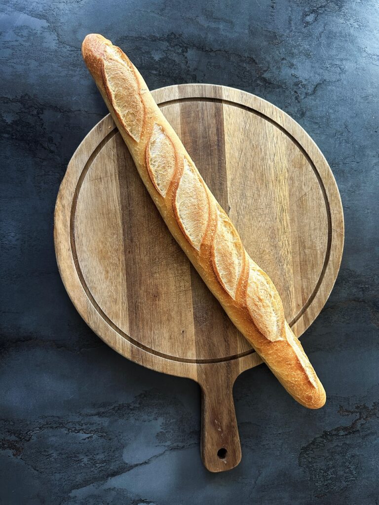 baguette, bread, french, france, french bread, loaf, golden, brown, marble, blue, cutting board, kitchen, classic, iconic, perfect, loaf of french bread, classic baguette, paris, culinary, cook, bake, fresh, fresh bread